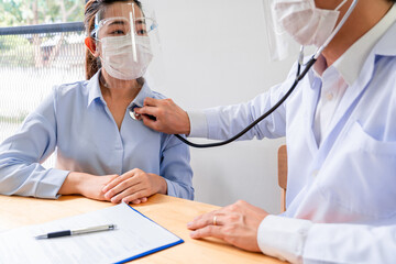 Medical concept a female doctor examining the patient by using stethoscope on the patient’s breast