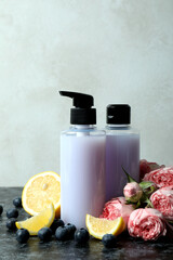 Natural shower gels and ingredients against white textured background