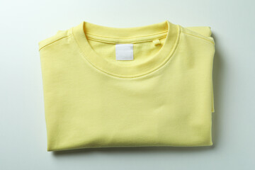 Yellow sweatshirt on white background, space for text