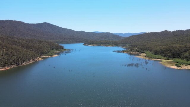 Slow moving drone shot of Bright Blue Water and Mountains near Lake Eildon, Victoria Australia