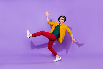 Full length body size view of attractive cheerful guy having fun fooling isolated over bright violet purple color background