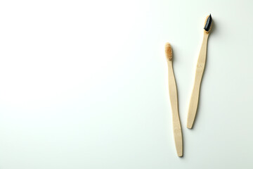 Eco friendly wooden toothbrushes on white background