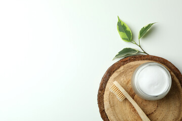 Board with eco friendly toothbrush and tooth powder on white background