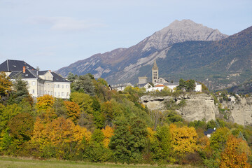 Fototapeta na wymiar view of Embrun town on the cliff in the fall in the southern Alps, France