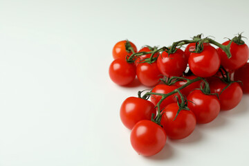 Fresh cherry tomato branches on white background