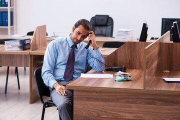 Young male employee working in the office