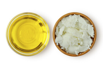 Argan oil in glass bowl and karité shea butter in wooden bowl on white background - 433403176