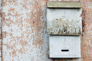 Old mailbox for paper letters. Rusted metal blue wall