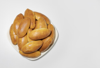 Homemade pies on a rectangular dish. On a white background, close-up, top view