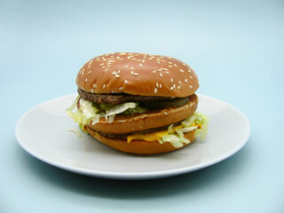 hamburger with beef and vegetables on a plate.