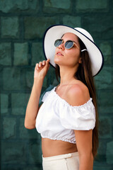 Portrait of a happy beautiful woman wearing a hat and posing