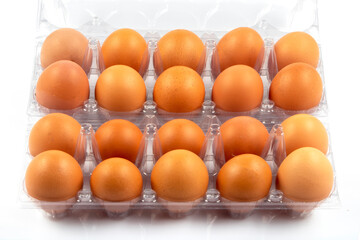 Overhead view of brown chicken eggs in an open egg box isolated on white background. Fresh chicken eggs. Natural healthy food and organic farming concept. Eggs in box.