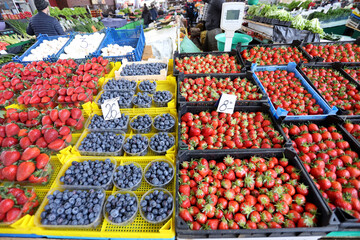 Carpet of blueberries and strawberries at a farmer market