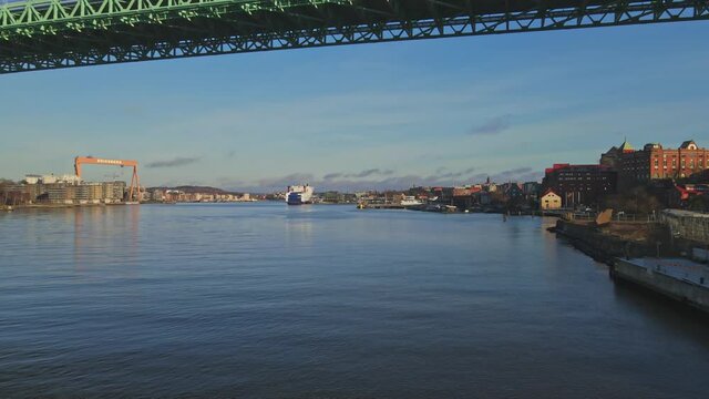 Drone Flying Under Alvsborgsbron Bridge With Eriksberg's Crane In The Distance At Gothenburg, Sweden. - aerial