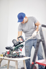 Young adult man working on a DIY budget renovation of his new home apartment.