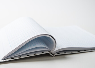 An expanded notebook for notes. Selective focus. Blurred background.