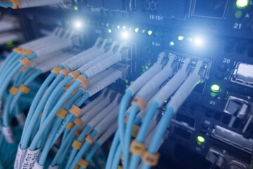 Close up fiber optic and hub telecommunication in server room.	
