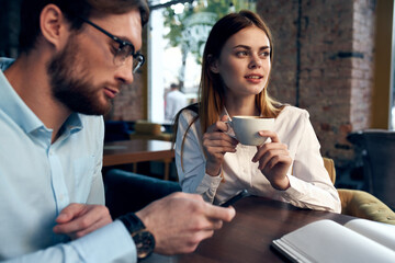 business men and woman sitting in a cafe a cup of coffee leisure communication