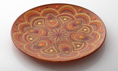 Yellow decorative plate with a mandala pattern