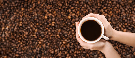 A cup of coffee in hands. Background of kogo bean - obrazy, fototapety, plakaty
