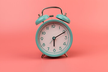 Old clock isolated on a pink background with space for text. Concept of time