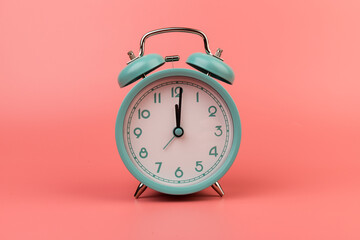 Old clock isolated on a pink background with space for text. Concept of time