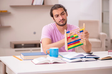 Young male student preparing for exams at home