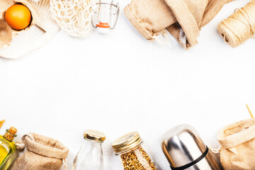 Recyclable, reusable eco friendly bags, package, bottles, cans and storage containers, mesh bag. White background, top view. Zero waste, plastic free and sustainable lifestyle concept