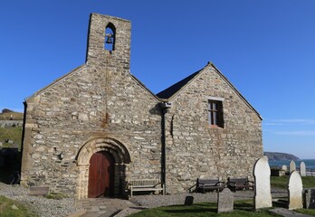 Fototapeta na wymiar St Hywyn's, an ancient church with a Norman doorway at Aberdaron, Llyn Peninsula, Gwynedd, Wales, UK.