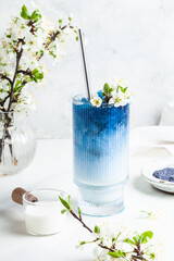 Blue matcha latte in a glass.