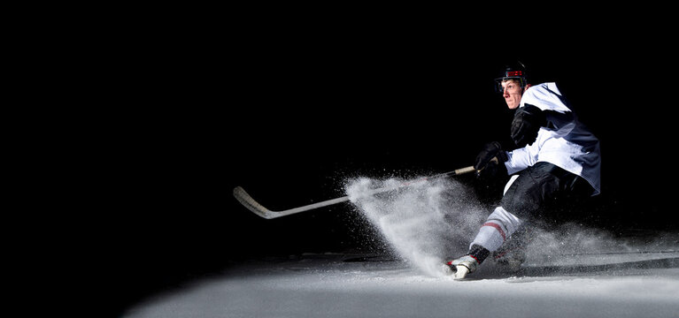 Ice Hockey Player In Action Kicking With Stick