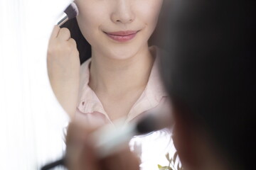 Woman applying make up with brush