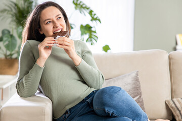 Woman biting a chocolate bar