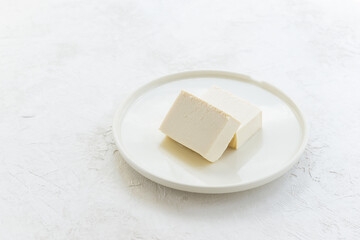 Tofu slices on a light background.