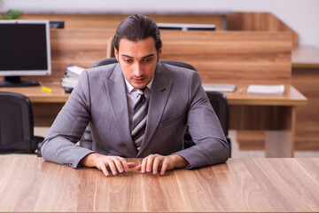 Fototapeta premium Young businessman employee sitting in the office