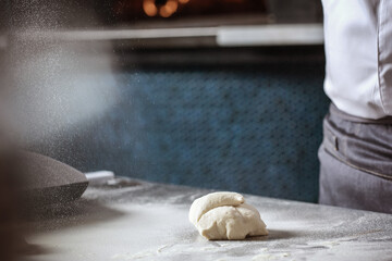 Making dough for bread by male hands in restaurant kitchen. Cooking concept.