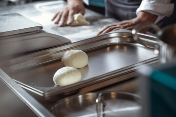 Making dough for bread by male hands in restaurant kitchen. Cooking concept.