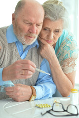 ill Senior couple with pills
