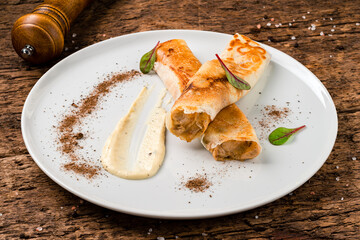 tasty stuffed pancakes crepes with meat closeup. Thin pancakes with fillings. Russian Fried Stuffed Pancakes Blintzes with Meat. Food photography.