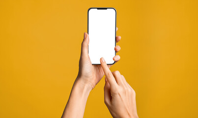 Fototapeta na wymiar Hands using smartphone on orange background