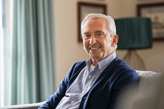 Happy senior man sitting at home