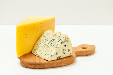 Fourme d'Ambert and cheese hit fitness on wooden cutting board