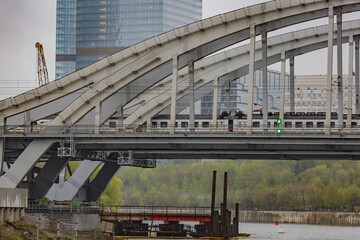 Naklejka premium Transport bridge over the Moskva River in the russian capital on a cloudy day. Moscow, Russia
