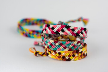 Fototapeta premium Group of handmade homemade colorful natural woven bracelets of friendship isolated on white background