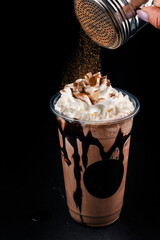 Chocolate cookie milkshake in tall mugs with chocolate whipped cream