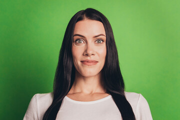 Fototapeta premium Portrait of shocked astonished woman isolated over green background