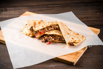 mexican quesadilla with meat, pepper and sauce