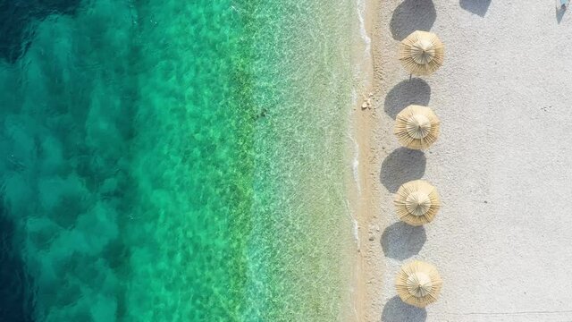 Aerial view on the beach. Vacation and adventure. Beach and blue water. Top view from drone at beach and blue sea. Travel and vacation video.