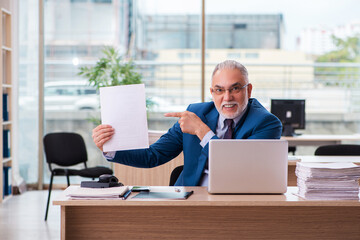 Old male boss employee working in the office