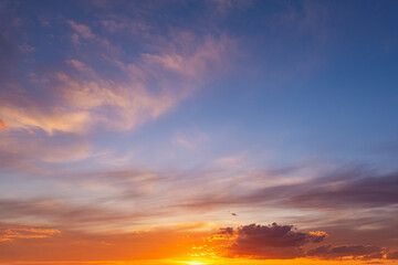 Dramatic colorful red orange to dark blue sunset or sunrise sky landscape clouds. Natural beautiful cloudscape dawn background wallpaper. Stormy windy nature twilight dusk scene panorama